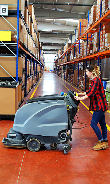 women cleaning warehouse floor