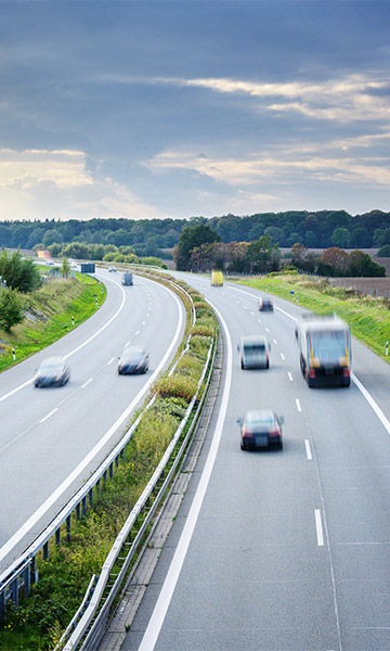 Vehicles traveling on a 4 lane highway.