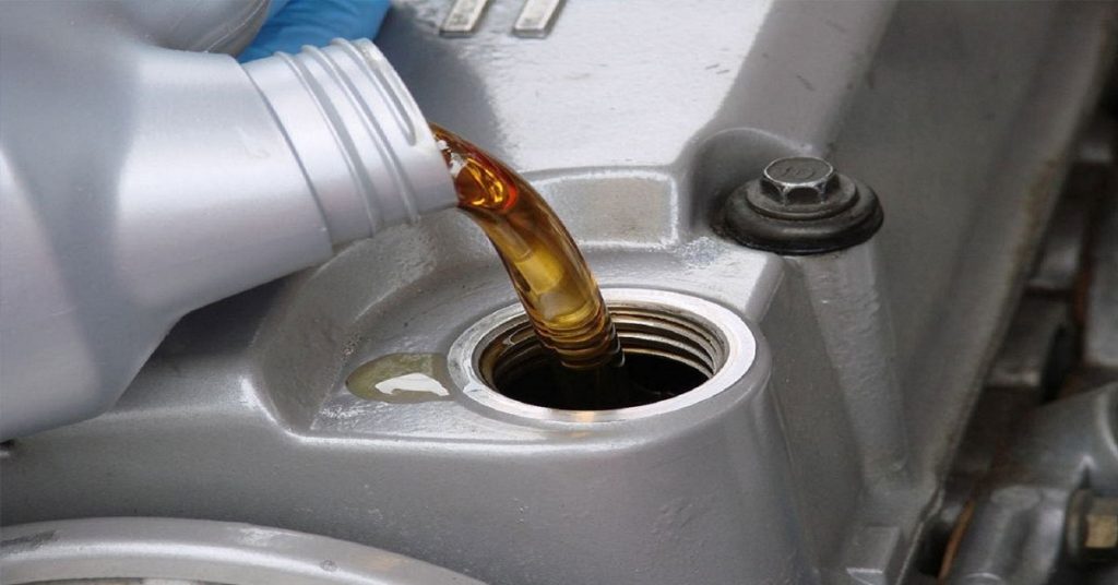 Lubricant oil pouring into a machine.
